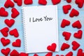 I LOVE YOU word on notebook with pink heart shape decoration on blue wooden table background. Wedding, Romantic and Happy Royalty Free Stock Photo